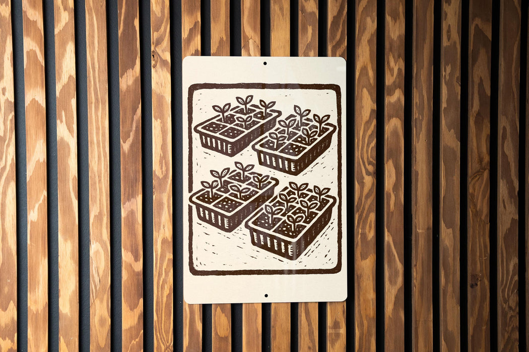 A sign with a black and white illustration of four identical plant pots with plants growing in them, mounted on a wooden wall.