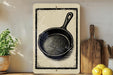a kitchen scene with a frying pan, wooden cutting board, and potted plant.