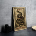 A metal sign with a snake design and the text "USA GARTER Snake" is displayed on a table.