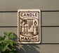 a sign that reads "CANDLE MAKING" with various candle-making illustrations on it, including a candle, wick, and other candle-making tools.