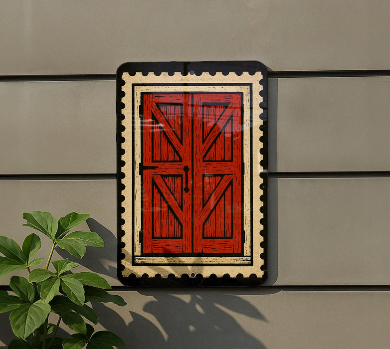 a red wooden door with a black border, mounted on a gray wall.