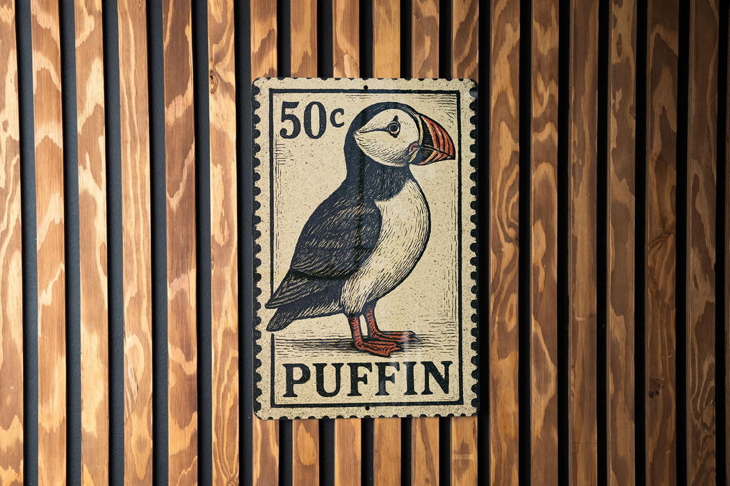 A 50 cent postage stamp featuring a puffin bird is displayed on a wooden wall.