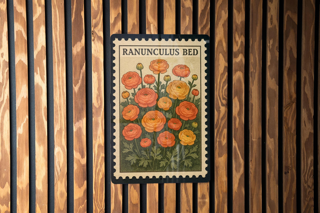 A vintage-style postage stamp featuring a floral illustration of Ranunculus flowers, which is affixed to a wooden wall.