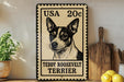 A vintage-style metal sign featuring a black and white illustration of a Teddy Roosevelt Terrier dog, with the text "USA 20c" and "Teddy Roosevelt Terrier" printed on it. The sign is displayed on a wooden shelf, with a potted plant and a wooden cutting board visible in the background.