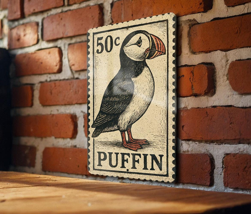 A vintage postage stamp featuring a puffin bird is displayed on a brick wall.