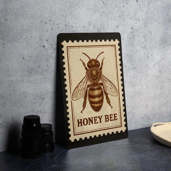 A framed image of a bee, specifically a honey bee, is displayed on a table.