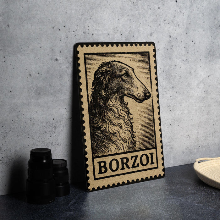 A framed image of a dog, specifically Borzoi, is displayed on a table.