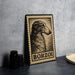 A framed image of a dog, specifically Borzoi, is displayed on a table.