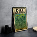A metal sign with the text "DILL GARDEN" and an illustration of a plant is displayed on a table next to some black camera lenses.