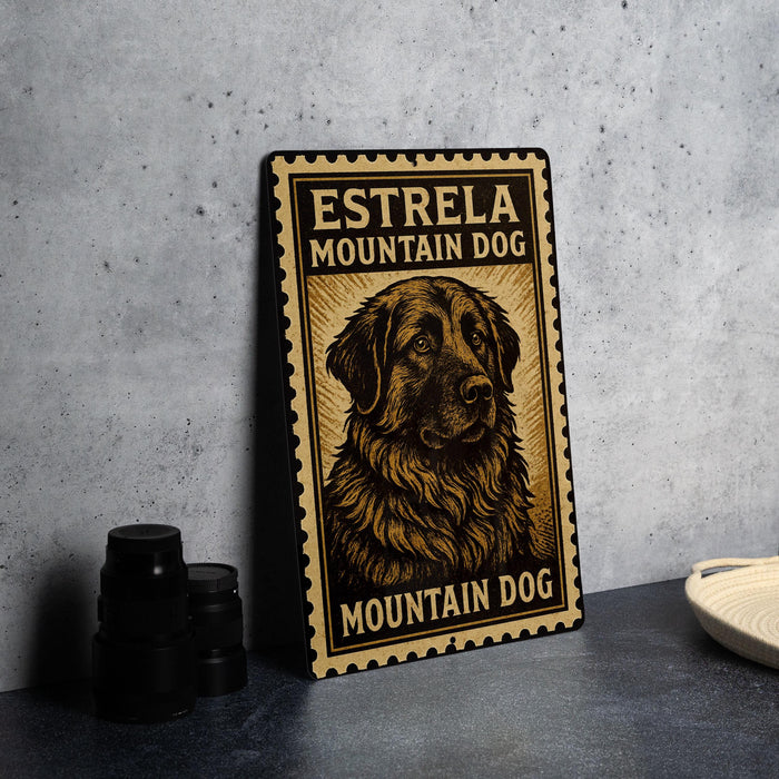 A metal sign with a dog illustration and text, placed on a countertop next to some black camera lenses.