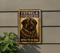 a sign with a dog on it, mounted on a wall.