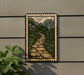 a framed illustration of a stone path winding through a lush, green landscape with flowers and foliage.