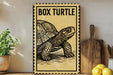 a sign with a picture of a box turtle, placed on a wooden surface next to a wooden cutting board and some lemons.