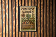 A vintage-style stamp or postcard with a garden scene, featuring a wooden bench, a flower, and a pile of compost.