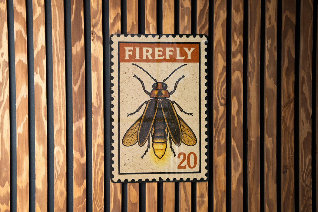 A framed image of a Firefly insect, with the text "FIREFLY" and the number "20" printed on it, is displayed on a wooden wall.