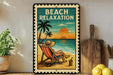 A framed vintage-style sign with a beach scene, featuring a person relaxing in a chair and a palm tree, with the text "BEACH RELAXATION" prominently displayed.