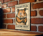 A wooden table with a metal stamp featuring a hamster eating a seed on it, mounted on a brick wall.