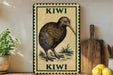 a decorative sign with a kiwi bird illustration, placed on a wooden surface next to a wooden cutting board and some lemons.