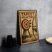 a metal sign with a target and arrows, placed on a table next to some black camera lenses.