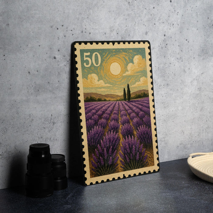 A framed postage stamp depicting a lavender field with a sun and clouds in the background.