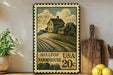 A vintage-style metal sign depicting a farmhouse with a hilltop view, mounted on a wall next to a wooden cutting board and a potted plant.