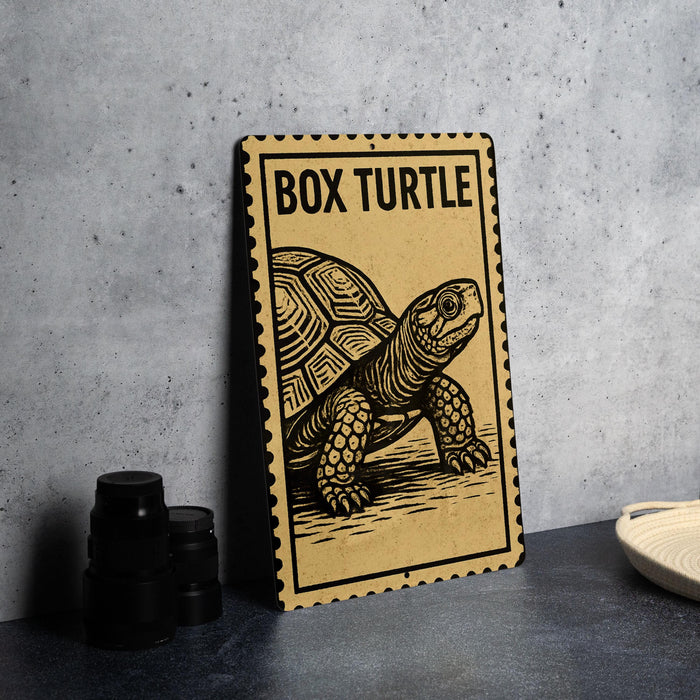 A wooden sign with a picture of a box turtle on it, placed on a table next to some black camera lenses.