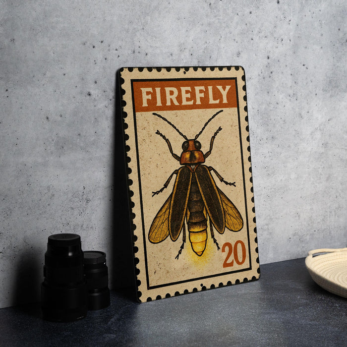 A metal stamp featuring a detailed illustration of a Firefly insect, with the text "FIREFLY" prominently displayed.