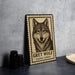 A framed image of a grey wolf is displayed on a wall, with a plate and a stack of black camera lenses to the left.