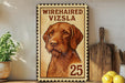 A framed illustration of a wirehaired vizsla dog, with the text "WIREHAIRED VIZSLA 25" printed on it, is displayed on a shelf next to a wooden cutting board and some kitchen utensils.