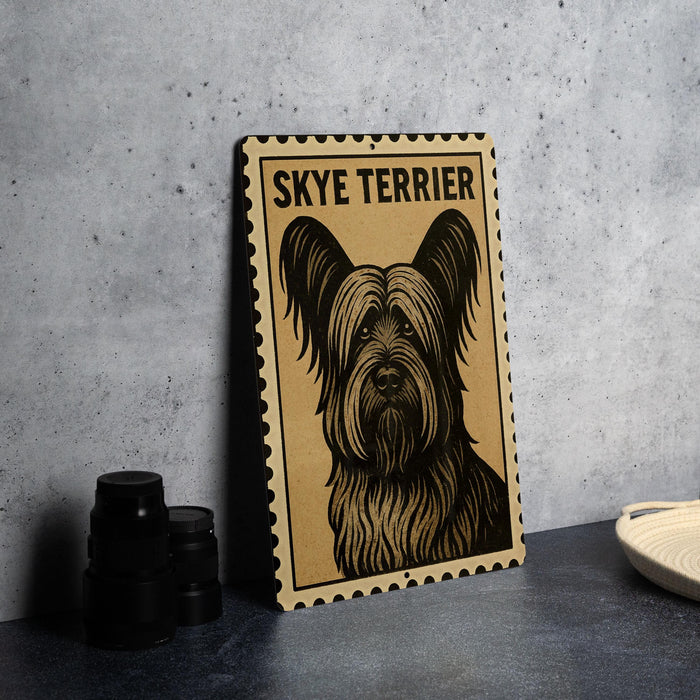 A framed poster of a Skye Terrier dog is displayed on a wall, with a stack of black camera lenses and a white dish visible to the right.