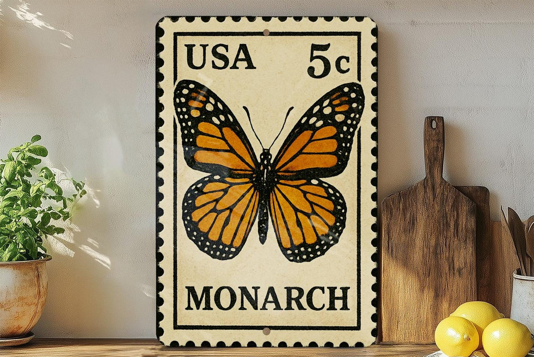 A framed US 5c postage stamp featuring a detailed illustration of a monarch butterfly is displayed on a wooden shelf, accompanied by a wooden cutting board, a potted plant, and some lemons.
