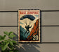 A vintage-style sign with a parachute and a person jumping off a cliff, mounted on a wall.