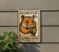 A metal sign with a hamster image and the text "HAMSTER 0c EATING SEED" is mounted on a wall.