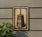 a wooden barrel with a handle, mounted on a wall.