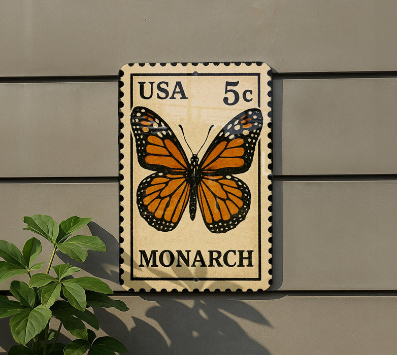 A US 5c postage stamp featuring a detailed image of a monarch butterfly is displayed on a wall.