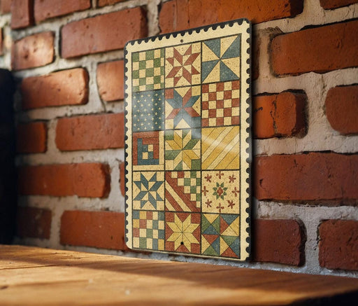 a wooden table with a colorful, vintage-style quilt hanging on the brick wall behind it.