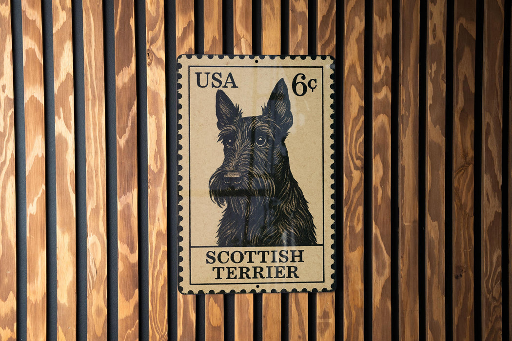 A black and white postage stamp featuring a portrait of a Scottish Terrier dog.