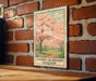 A vintage-style metal sign with a cherry blossom tree illustration is mounted on a brick wall.