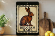 A framed illustration of a brown hare is displayed on a shelf, accompanied by a wooden cutting board and a potted plant.