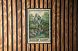 A framed illustration of a rock garden is displayed on a wooden wall.