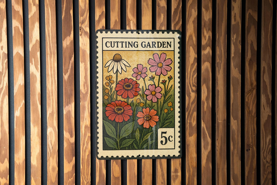 A vintage-style stamp depicting a garden scene with flowers and plants, mounted on a wooden wall.