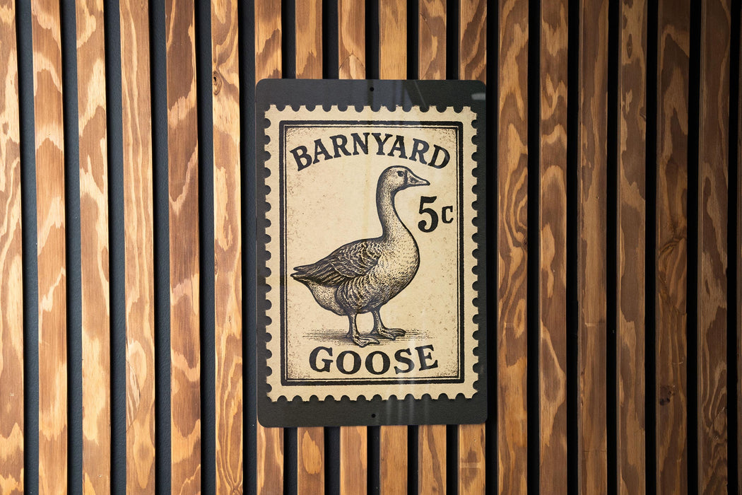 A sign featuring a goose on a postage stamp-like background, mounted on a wooden wall.