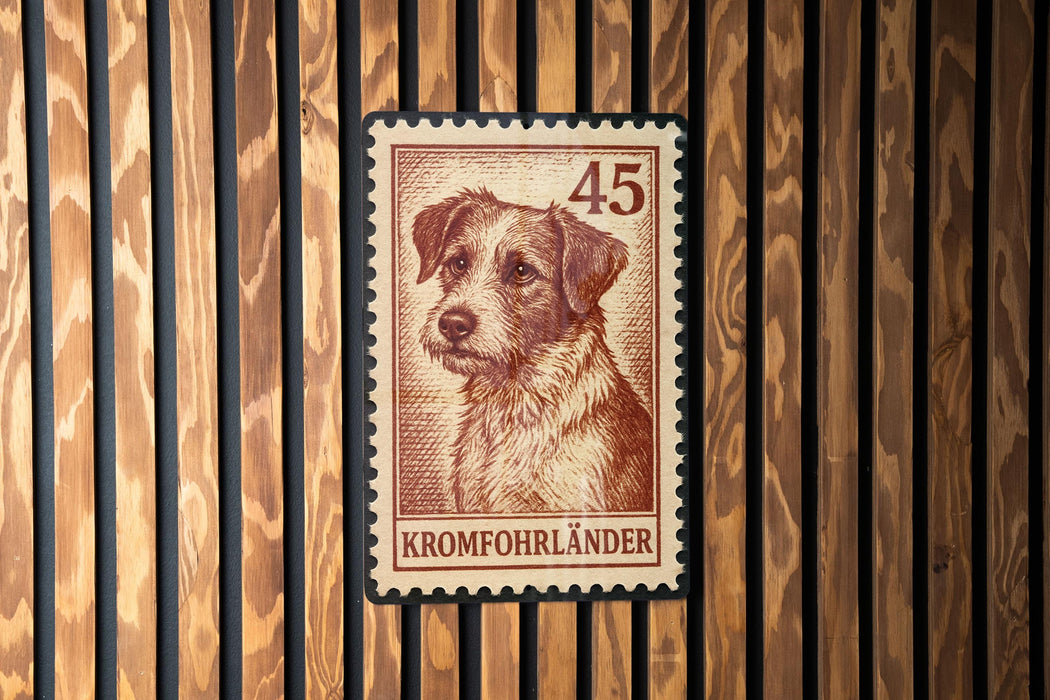 A brown and white dog is depicted on a brown and white postage stamp with the number 45, which is affixed to a wooden wall.