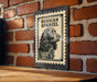 A poster of a Russian Spaniel dog is displayed on a brick wall.