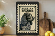 a framed illustration of a Russian Spaniel dog, with a wooden cutting board and a potted plant in the background.