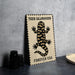 A metal sign with a tiger salamander illustration and the text "TIGER SALAMANDER FOREVER USA" on it, placed on a table next to some black camera lenses.