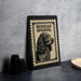 A framed image of a Russian Spaniel dog is displayed on a wall, with a black border and a stamp-like design.