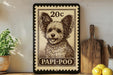 A framed image of a dog, specifically a Papi-Poo, is displayed on a shelf next to a wooden cutting board and some lemons.