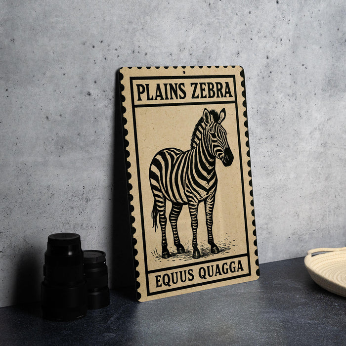A framed image of a zebra is displayed on a table, with a stack of black camera lenses to the left and a woven basket to the right.