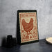 a framed illustration of a chicken surrounded by chicks, with the text "HEN AND CHICKS" prominently displayed.